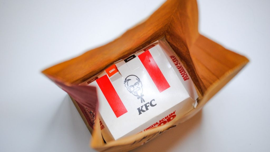 Una bolsa de papel con una caja de KFC dentro